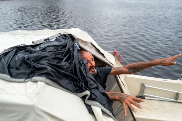 Tampa police try to persuade a man living on his boat known as 'Lieutenant Dan' to leave for his safety.