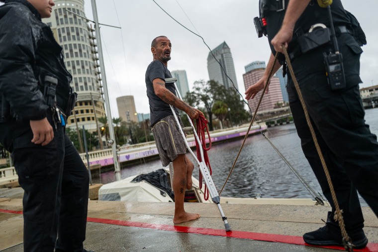 Tampa police try to persuade a man living on his boat known as 'Lieutenant Dan' to leave for his safety.